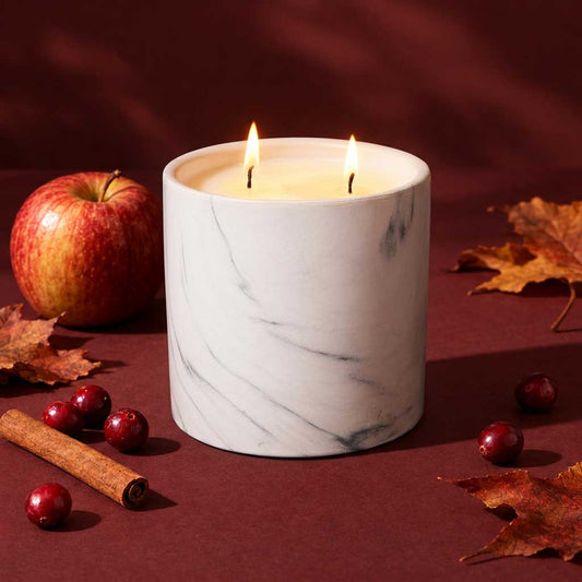 17oz white marble finish cylinder candle with two lit flames