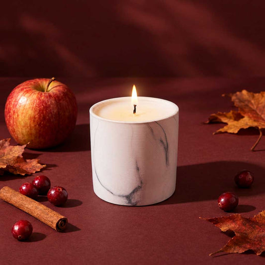 White marble 6 oz candle jar with lit wick