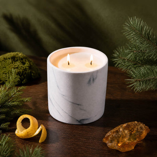 White marble-pattern candle jar with two lit wicks