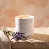White marble candle refill in white marble jar with two lit candle flames
