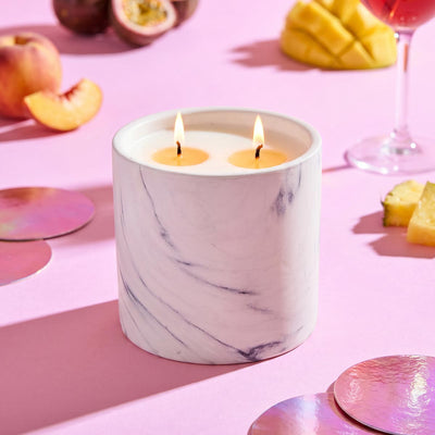 White marble candle refill in cylindrical jar with two lit wicks