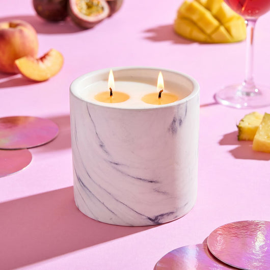 White marble candle refill in cylindrical jar with two lit wicks