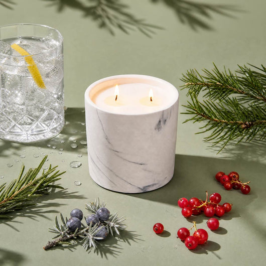 White marble candle refill in marble-look jar with two lit wicks
