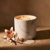 White marble candle refill in white marble cylinder with two lit wicks