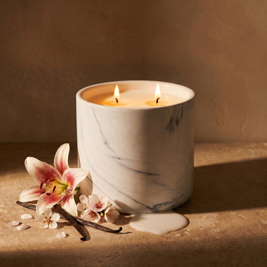 White marble candle refill in white marble cylinder with two lit wicks