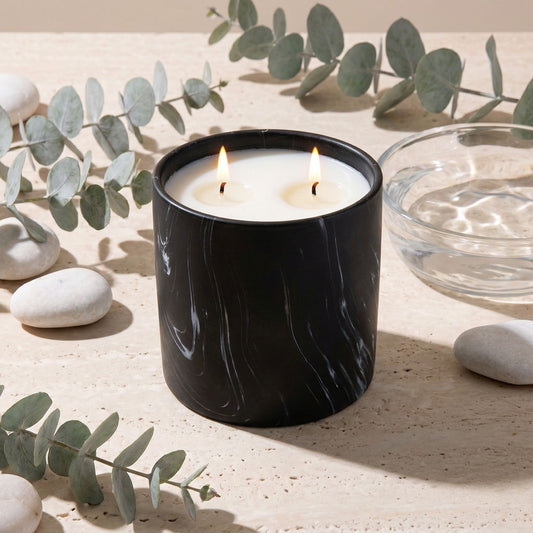Black marbled jar candle with two flames and white wax, top view