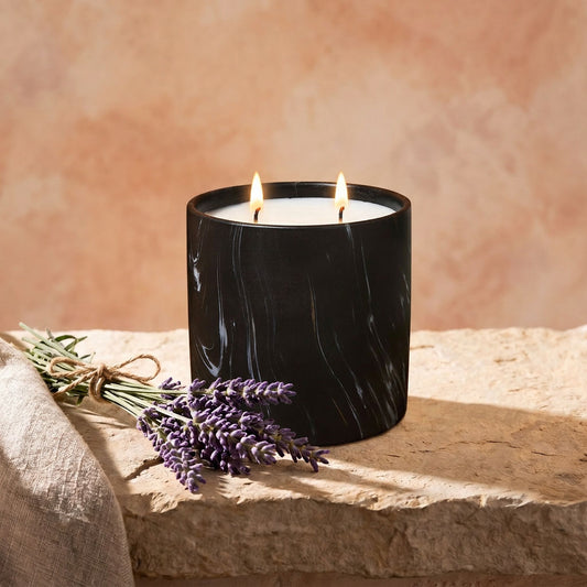 Black marbled jar candle with two flames and white wax, side angle