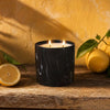 Black marbled jar candle with two flames and white wax, front angle