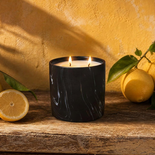 Black marbled jar candle with two flames and white wax, front angle