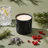 Black marble-pattern candle jar with two lit wicks and white wax surface
