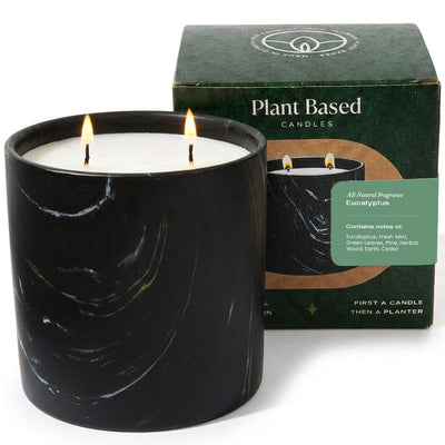 Black marbled candle in glass jar with two wicks, white wax; plant-based candle box behind