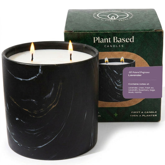 Black marble-style candle jar with two burning wicks, lavender plant-based scent