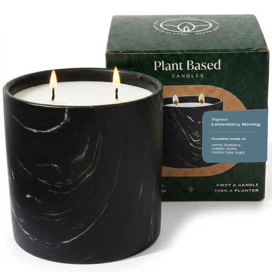 Black marbled plant-based candle with lit wick and white wax