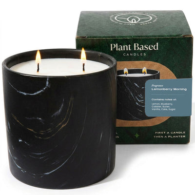 Black marbled plant-based candle with lit wick and white wax
