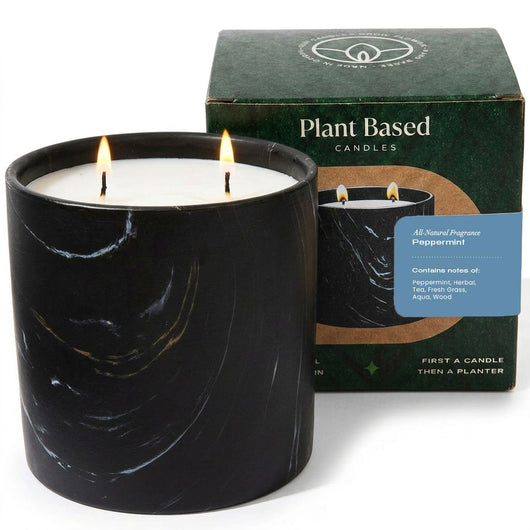 Black marbled peppermint candle in ceramic jar with flames; plant-based candles box behind
