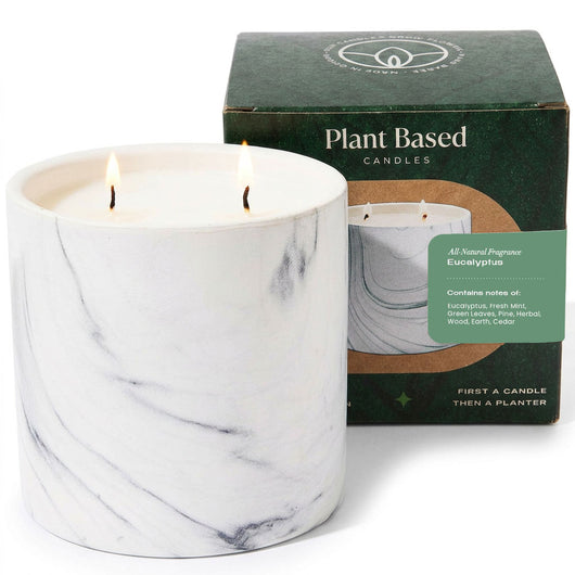 White marble plant-based candle jar with eucalyptus scent, lit flames, 17 oz