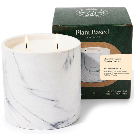 White marble-style jar candle with two wicks burning