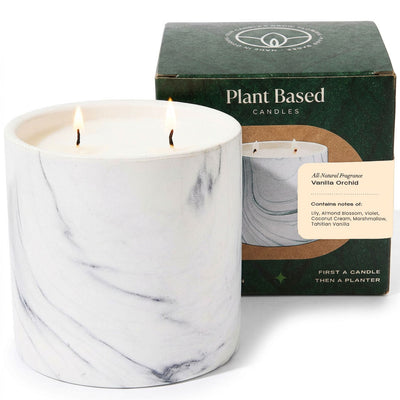 White marble-style jar candle with two wicks burning