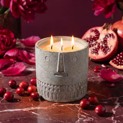 Gray textured stone-look candle with three flames in a round stone jar