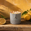 Gray textured candle jar with three flames