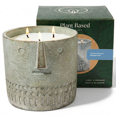 Stone-faced gray candle with three lit wicks and rectangular wick holder