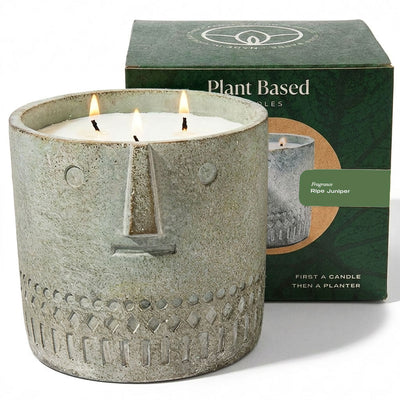 Stone-face candle, gray textured jar, three lit wicks, 27 oz