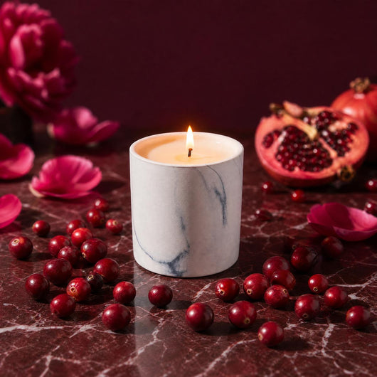 White marble-pattern candle refill with lit wick, gray swirls on white container