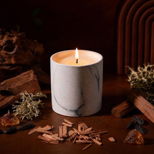 White marble-pattern candle refill with lit wick; white wax in marble-swirled jar