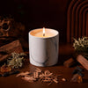 White marble Dapper Stranger candle with flame in a cylindrical container
