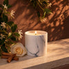 White marble jar candle with burning wick on stone surface