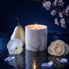 Lit white marble candle with smooth tumbler and subtle gray veining