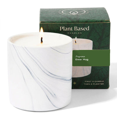 Marble-swirled white candle, lit wick, with matching gift box