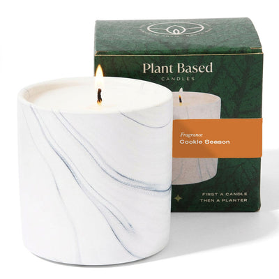 White marble candle jar with two wicks and Plant Based Candles box labeled Cookie Season