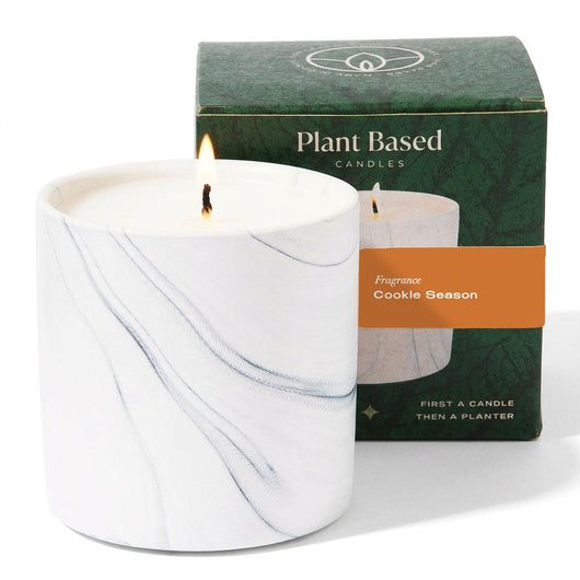 White marble candle jar with two wicks and Plant Based Candles box labeled Cookie Season