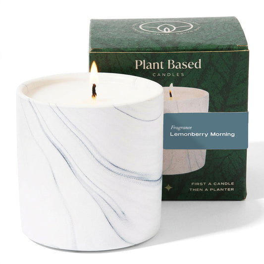 White marble plant-based candle in a glass jar with unlit flame, with green gift box