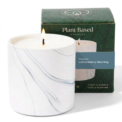 White marble plant-based candle in a glass jar with unlit flame, with green gift box