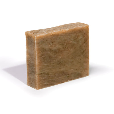 Organic soap bar in tan-brown, rectangular with speckled texture
