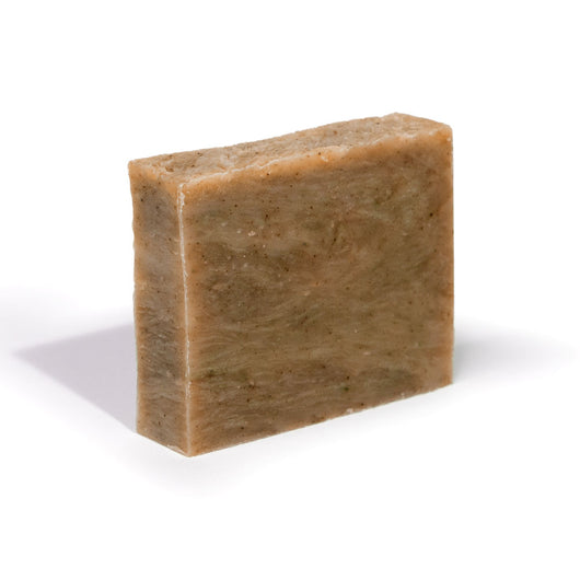 Organic soap bar in tan-brown, rectangular with speckled texture