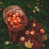 Organic soap fragrance scene with apples in wicker basket and brown cloth