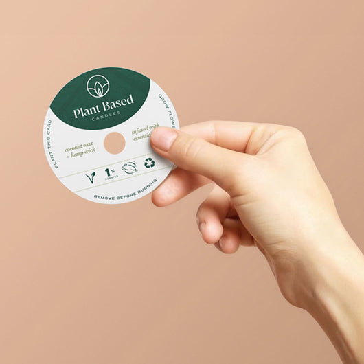 Plant Based candle warning seal disc being removed by hand