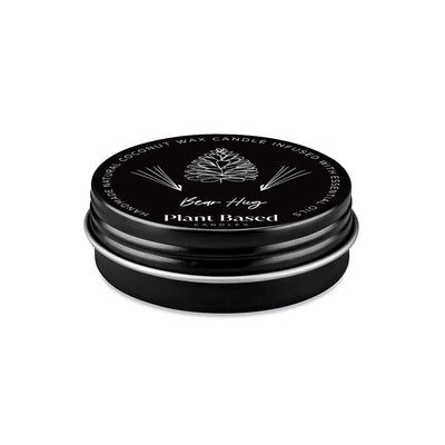 Black plant-based tealight tin lid, Bear Hug logo and pine-needle graphics