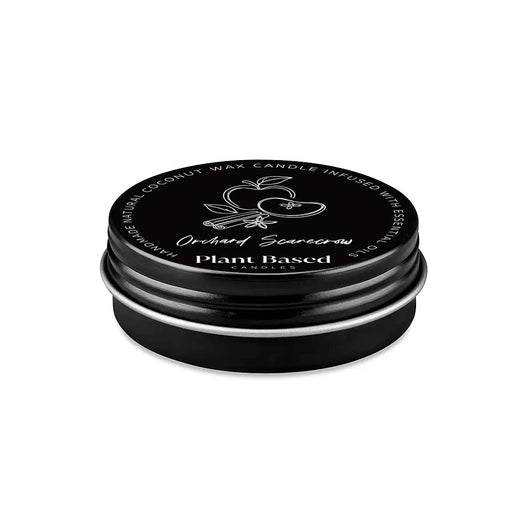 Tealight candle in dark round tin with black lid and printed label